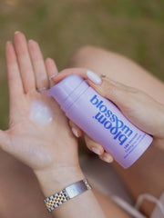 Pregnant woman dispensing the cooling refreshing serum of Leg Therapy to apply to her legs.