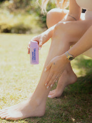 Pregnant woman applying Leg Therapy Cooling leg serum to legs, to keep them cool and refreshed.