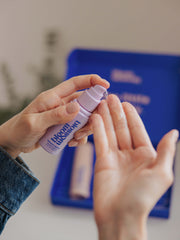 Dispensing stretch mark oil from bottle in a new mum and pregnancy gift set.