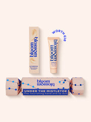 Blush Christmas cracker with shiny blue Christmas lights with a Nourishing lip balm and Age-defying hand cream inside.